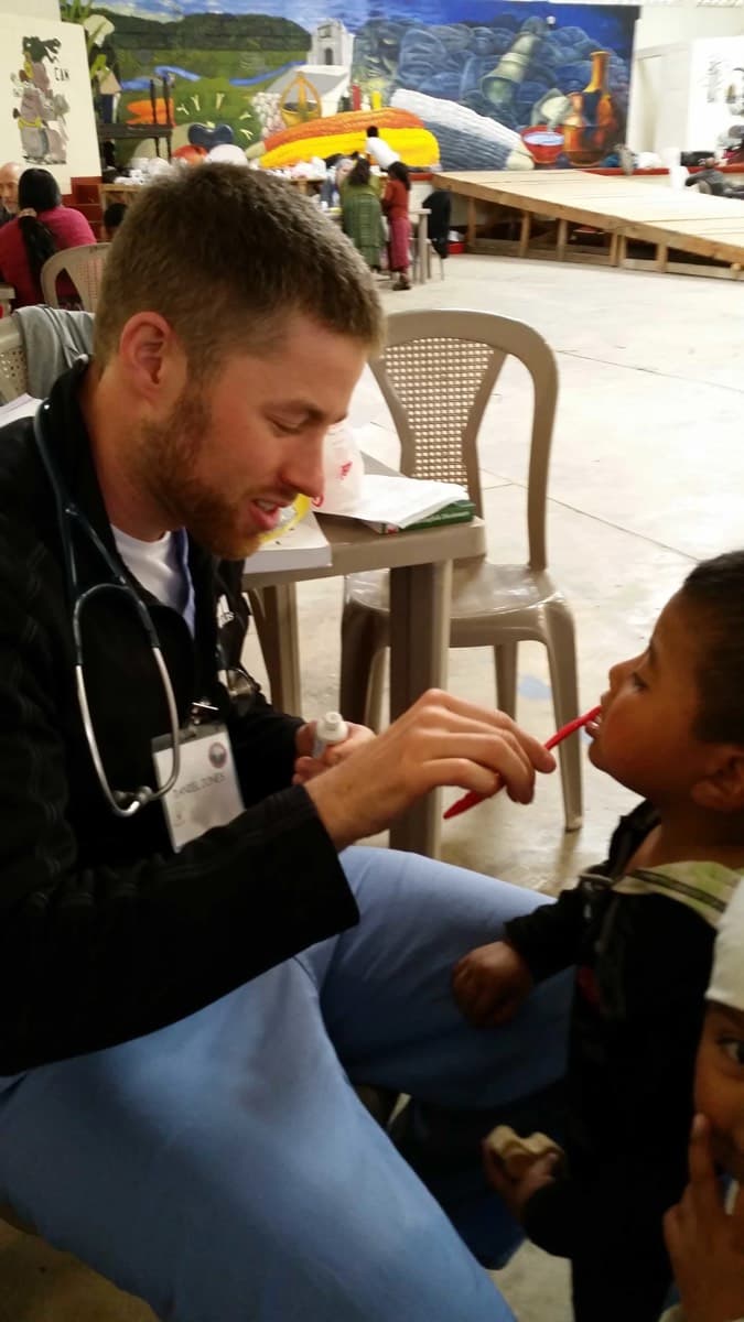 A physician examines a young patient during a clinic visit